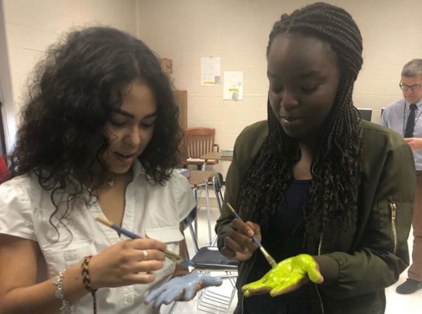 Picture of One of the First meetings of CAHS Culture Club; Two girls painting their hands